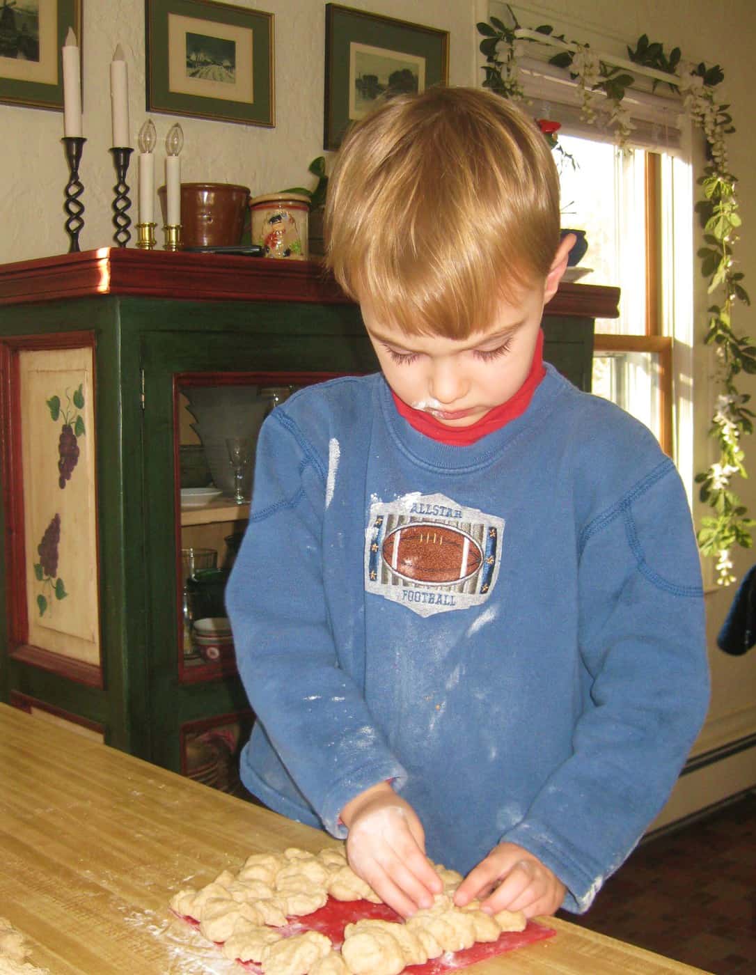 little boy baking bread in farmhouse kitchen