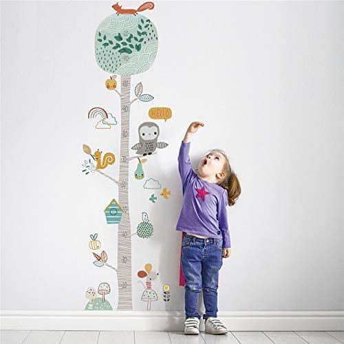 kids height measure decal wall decor with girl next to it