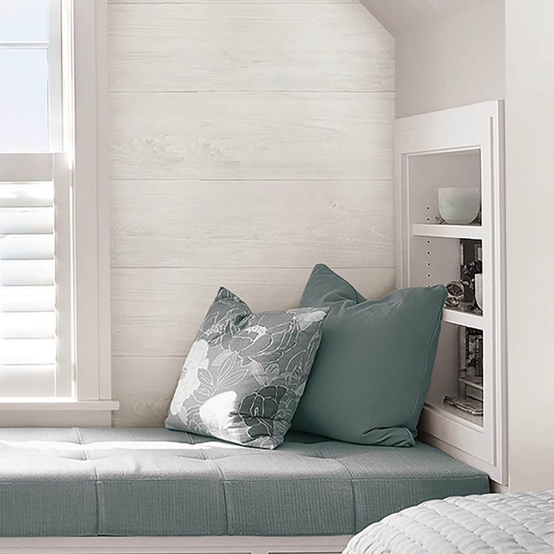 window seat with pillows, built-in wall shelf