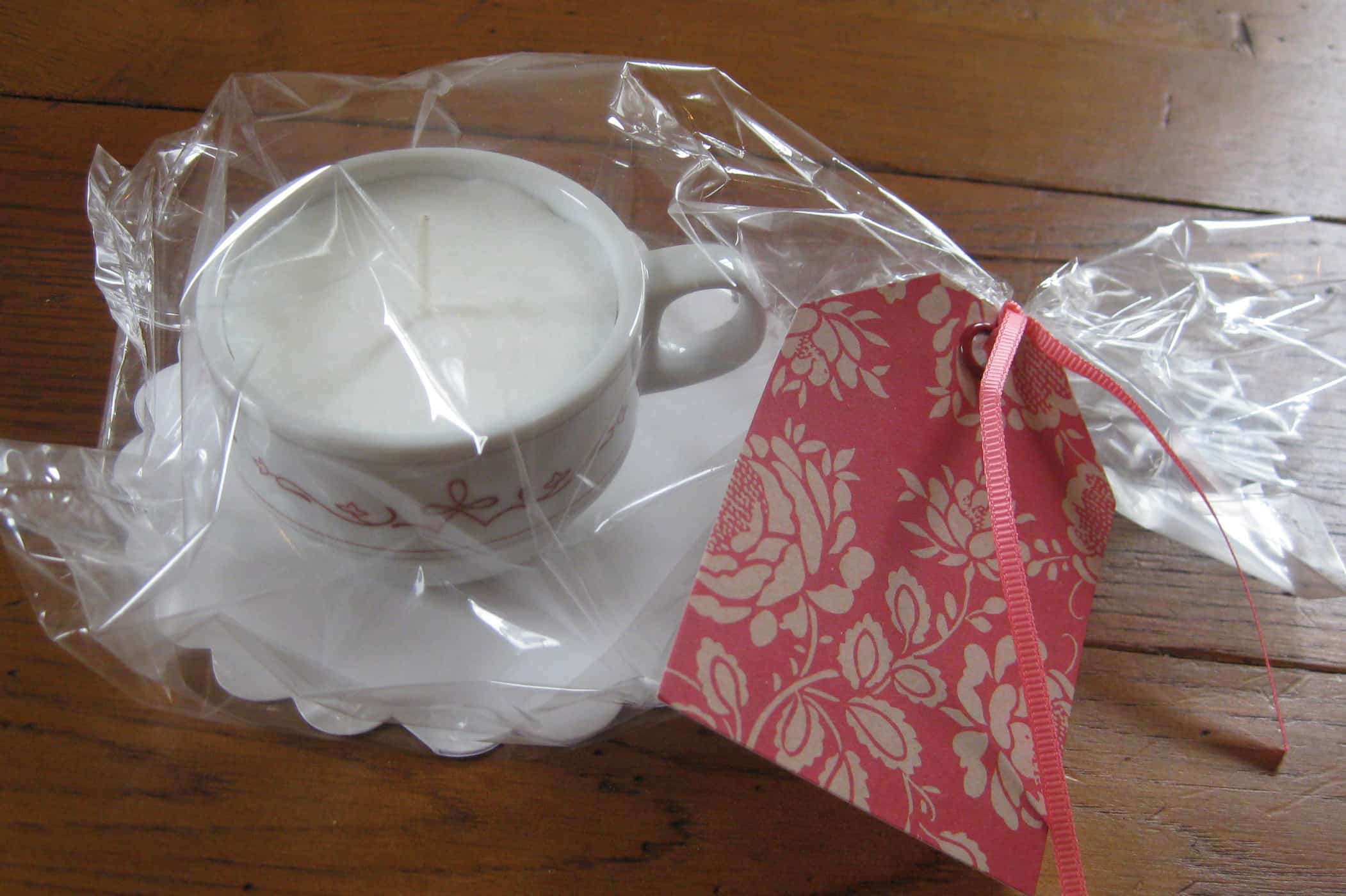 small teacup candle in cellophane bag with tag