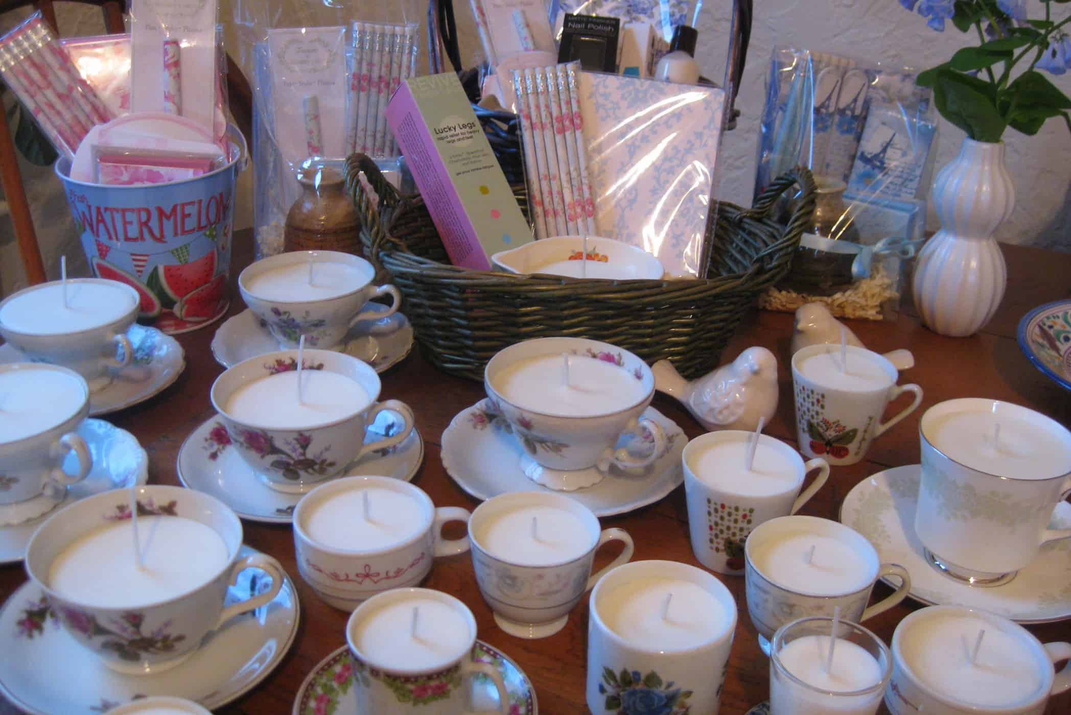 teacup candles and gift baskets on table