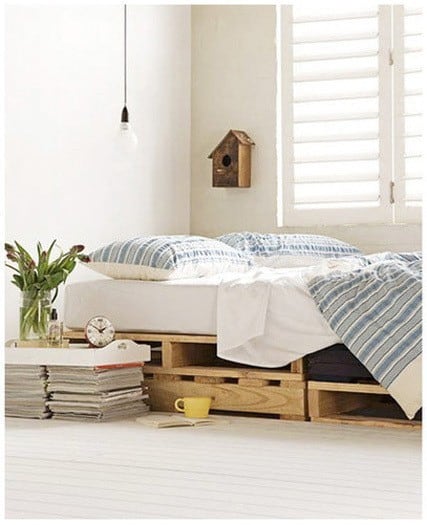 pallet bed in front of window with shutters