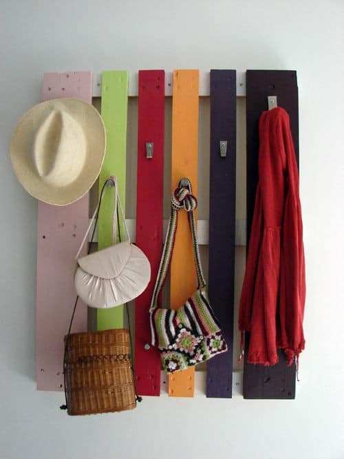 rack made out of pallet wood on wall with bags and scarf