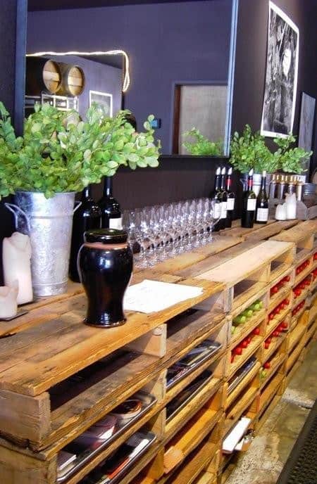 stacked pallets used for bar storage with wine bottles and glasses