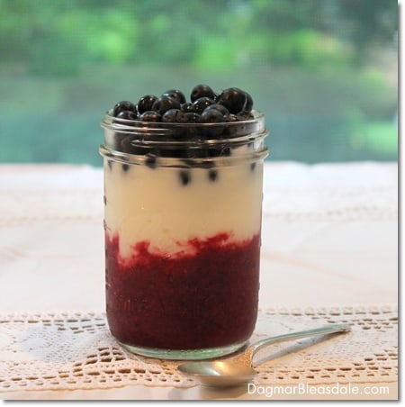 Patriotic Fourth of July Dessert of yogurt and berries in glass jar on table