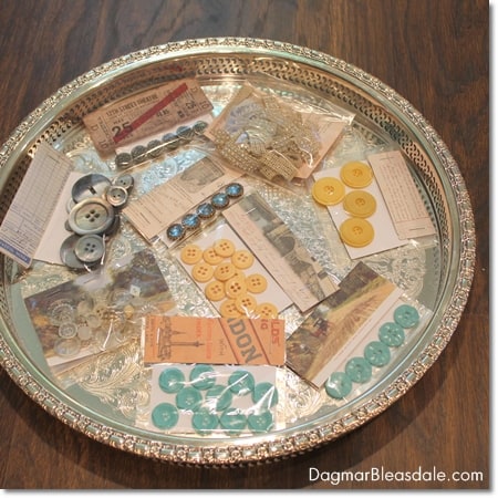 vintage buttons and paper goods on silver tray