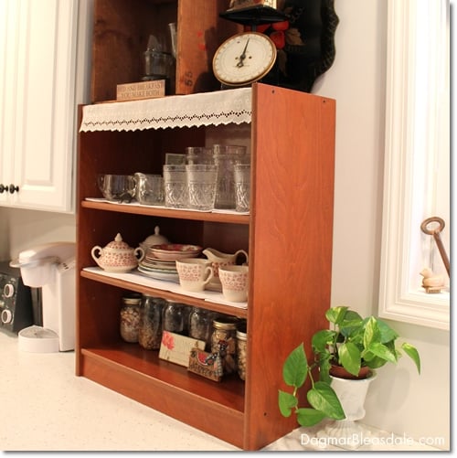 shelf with glasses and dishes on kitchen counter