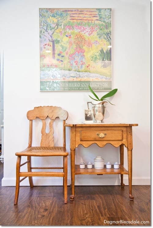 table and chair with colorful framed poster