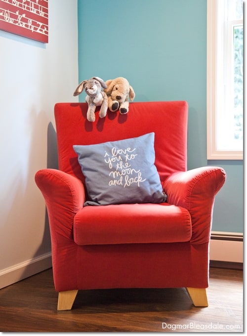 red chair with pillow and stuffed animals in kid's room