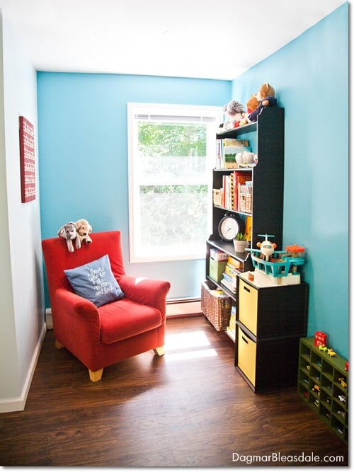turquoise kids room reading nook with chair and bookshelf