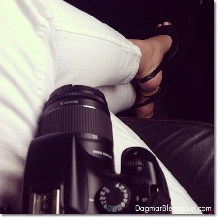 woman's legs in white jeans, black high heels with camera