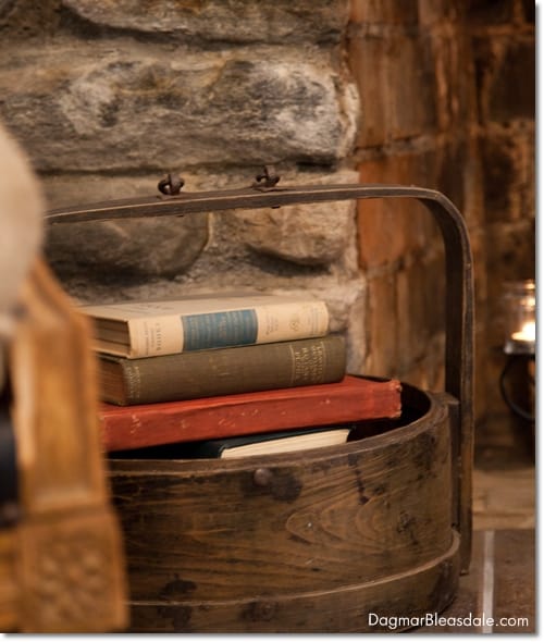wooden bucket with books in front of fireplace