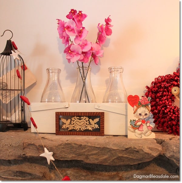 Valentine's Day mantel decor with milk bottles and bird cage