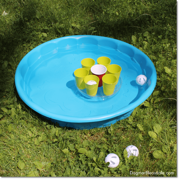 Pool Party Ball Toss Game in kid's pool on grass