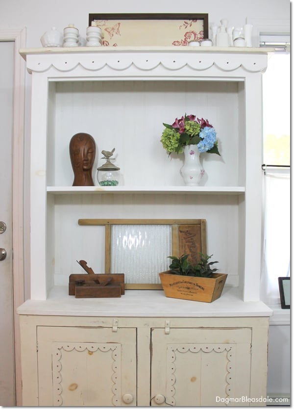 white hutch with decor pieces next to window