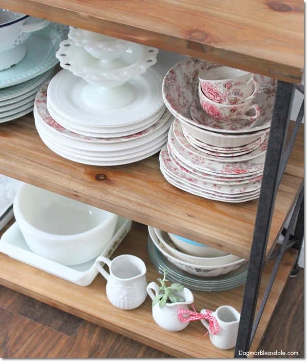 rustic console table with vintage dishes