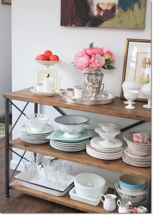 rustic console table with silver coffee carafe and dishes