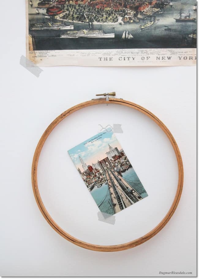 gallery wall with vintage embroidery hoop and postcard