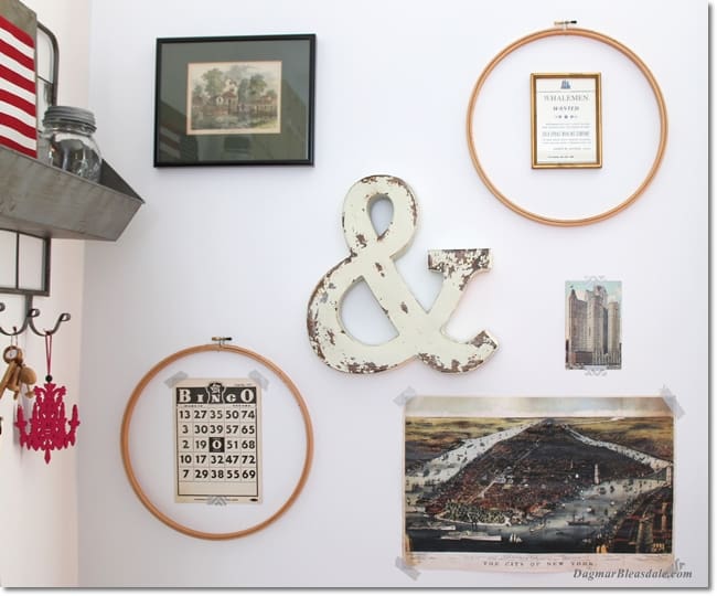 gallery wall with vintage embroidery hoops, flag, poster and postcards