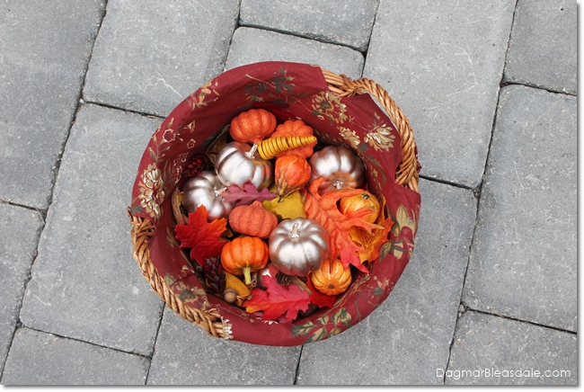small plastic pumpkins and leaves in basket