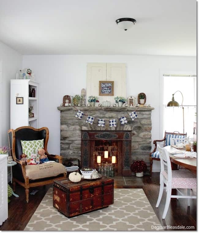 cottage living room with stone fireplace and fall decor