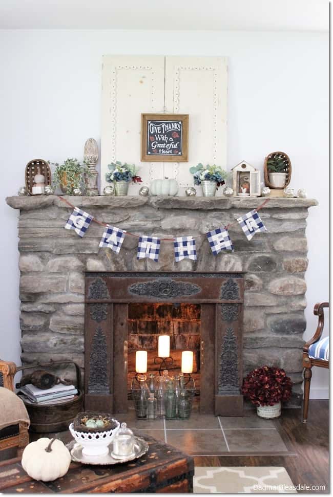stone fireplace, banner, and fall decor
