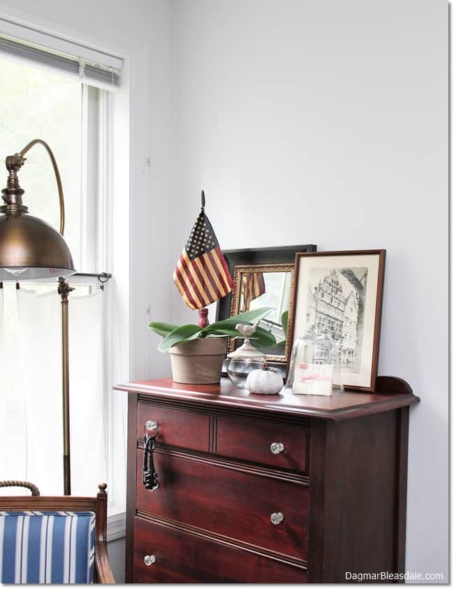 small dresser with flag and mirror and pumpkin