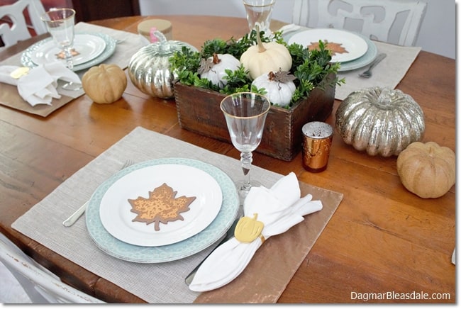 Fall table setting with pumpkins abd leaves
