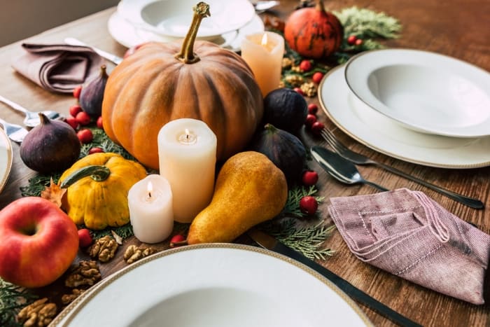  Thanksgiving decor on table, plates, pumpkins, candles