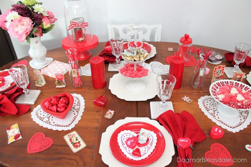 Valentine’s Day Tablescape with many red items, plates, candles