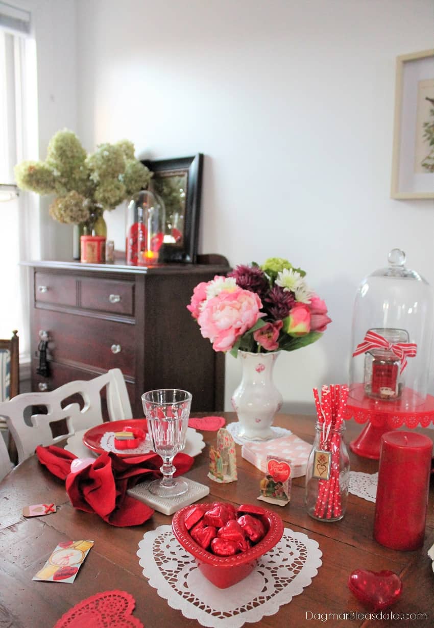 table decorated for Valentine's Day dinner with many red items
