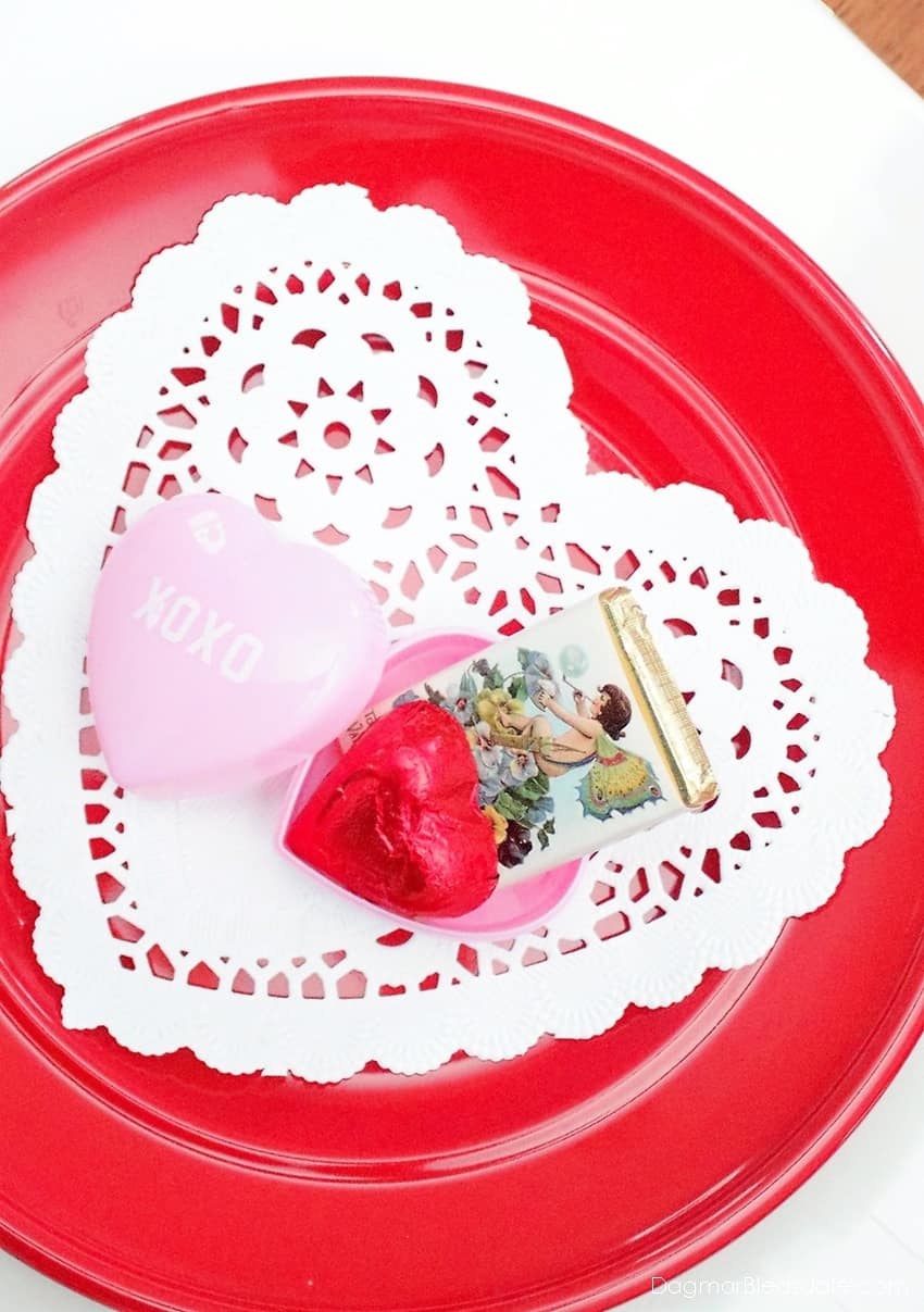 red plate with heart doily and chocolate