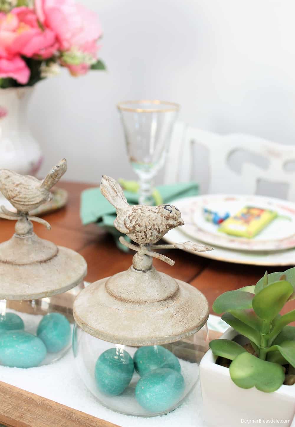 Easter tablescape, glass bowls with eggs and bird top