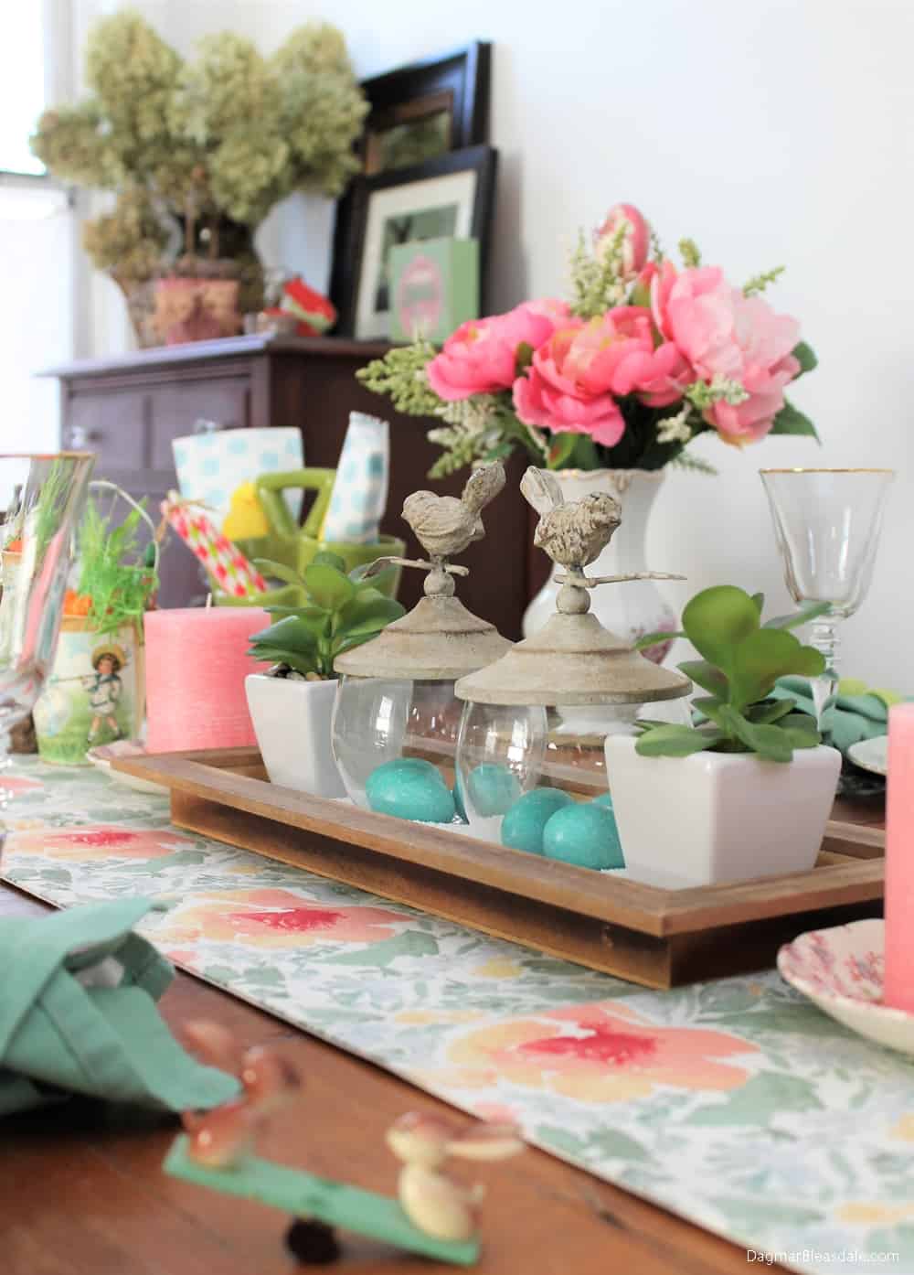 Easter decor on table, tray with flowers, bird decor, and candles