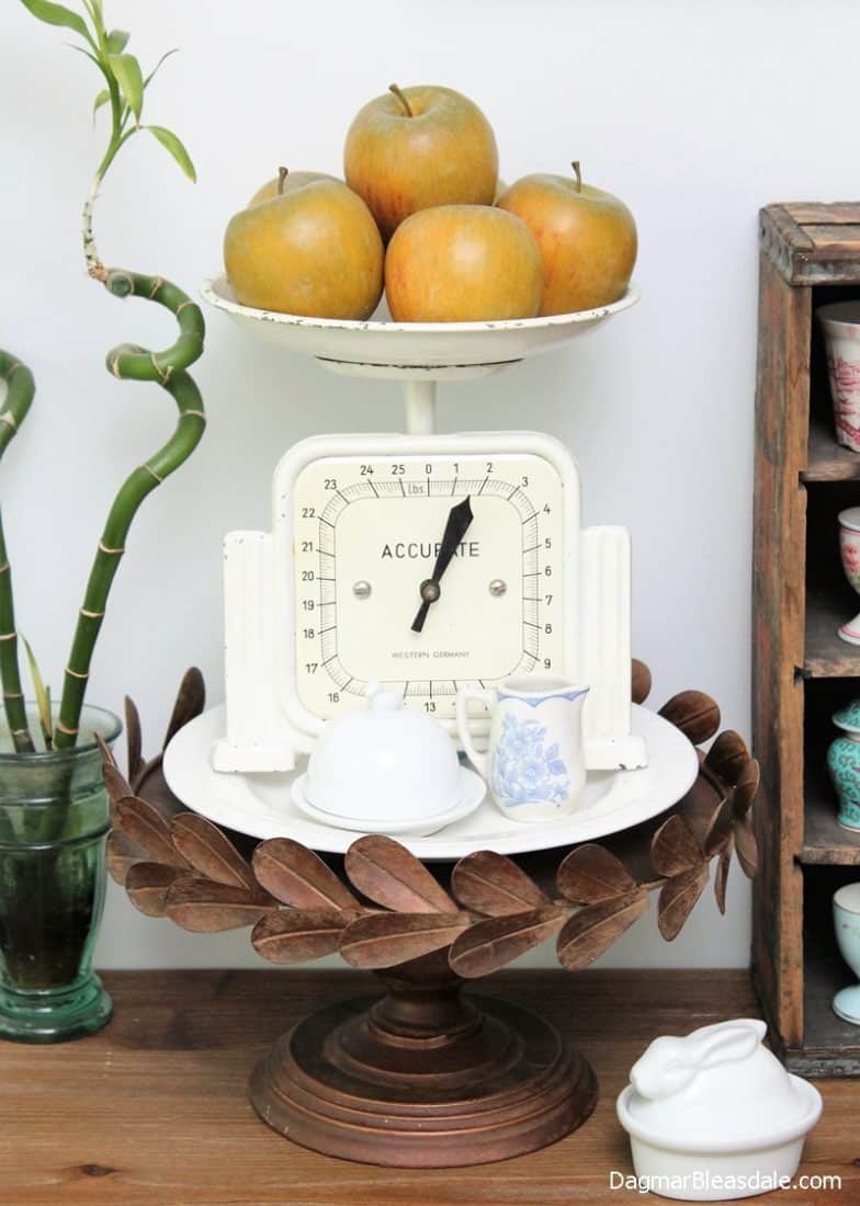 rustic cake stand with scale and apples on table
