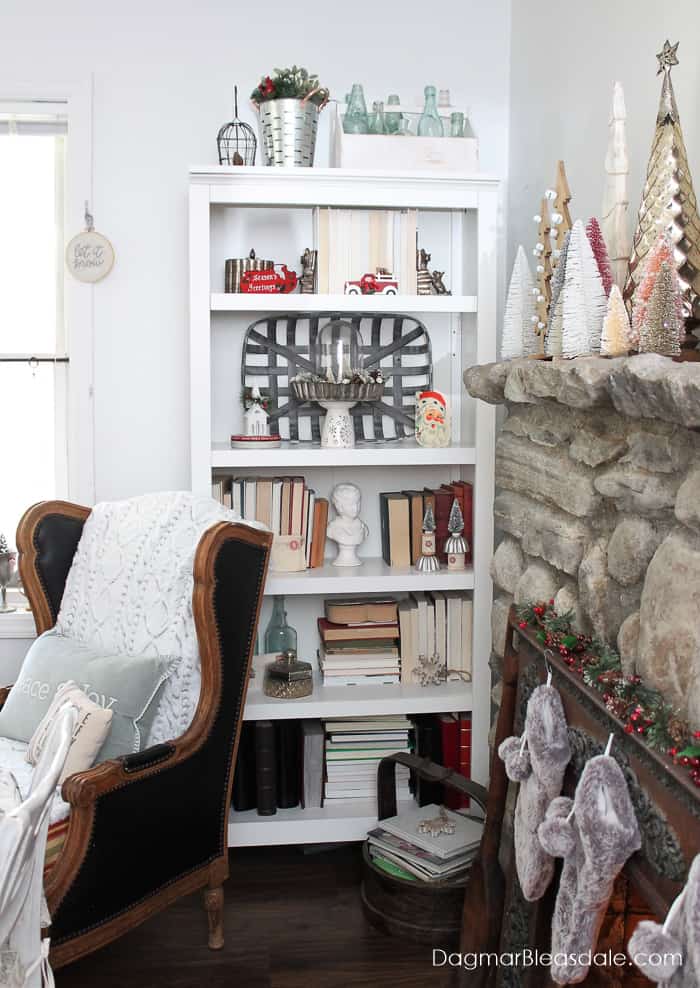 stone fireplace and shelf decorated with Christmas decor