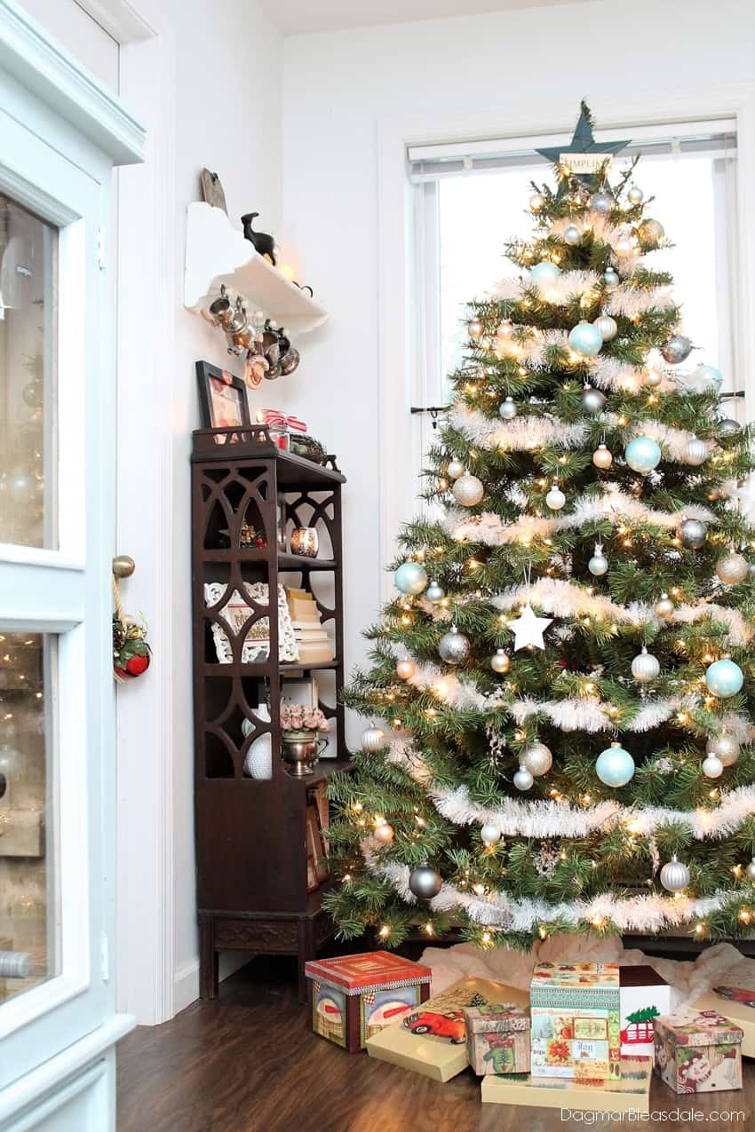 Blue and metallic Christmas tree and shelf with decor