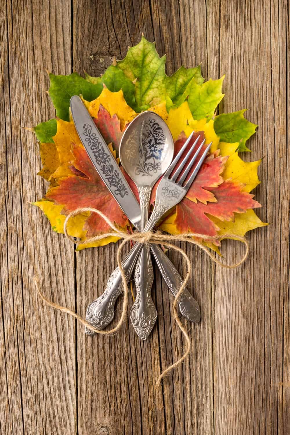 vintage silverware with faux leaves and string